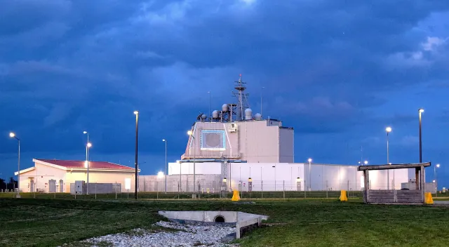 The Aegis Ashore deckhouse at Naval Support Facility Deveselu, Romania, under storm clouds
