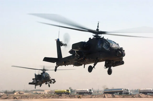 Two U.S. Army AH-64 Apache helicopters taking off in Iraq