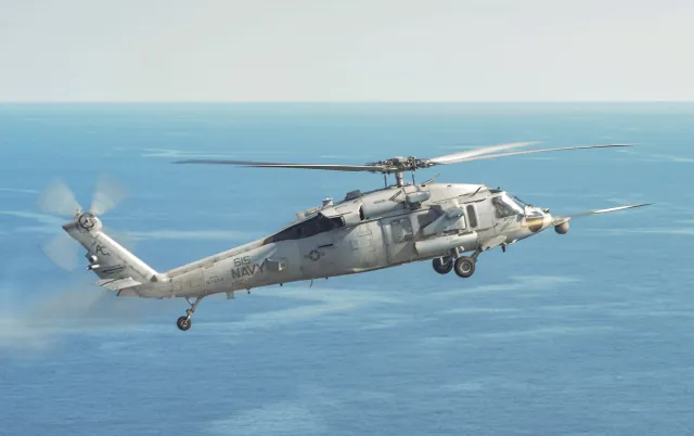 An MH-60S Sea Hawk helicopter firing an APKWS II laser-guided rocket off the Virginia coast