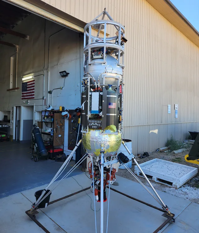 Astrobotic Xodiac vertical-takeoff test rocket outside a hangar