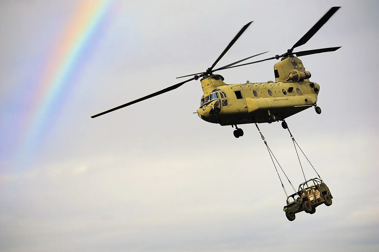 A U.S. Army CH-47 Chinook carrying a vehicle on a sling during an exercise