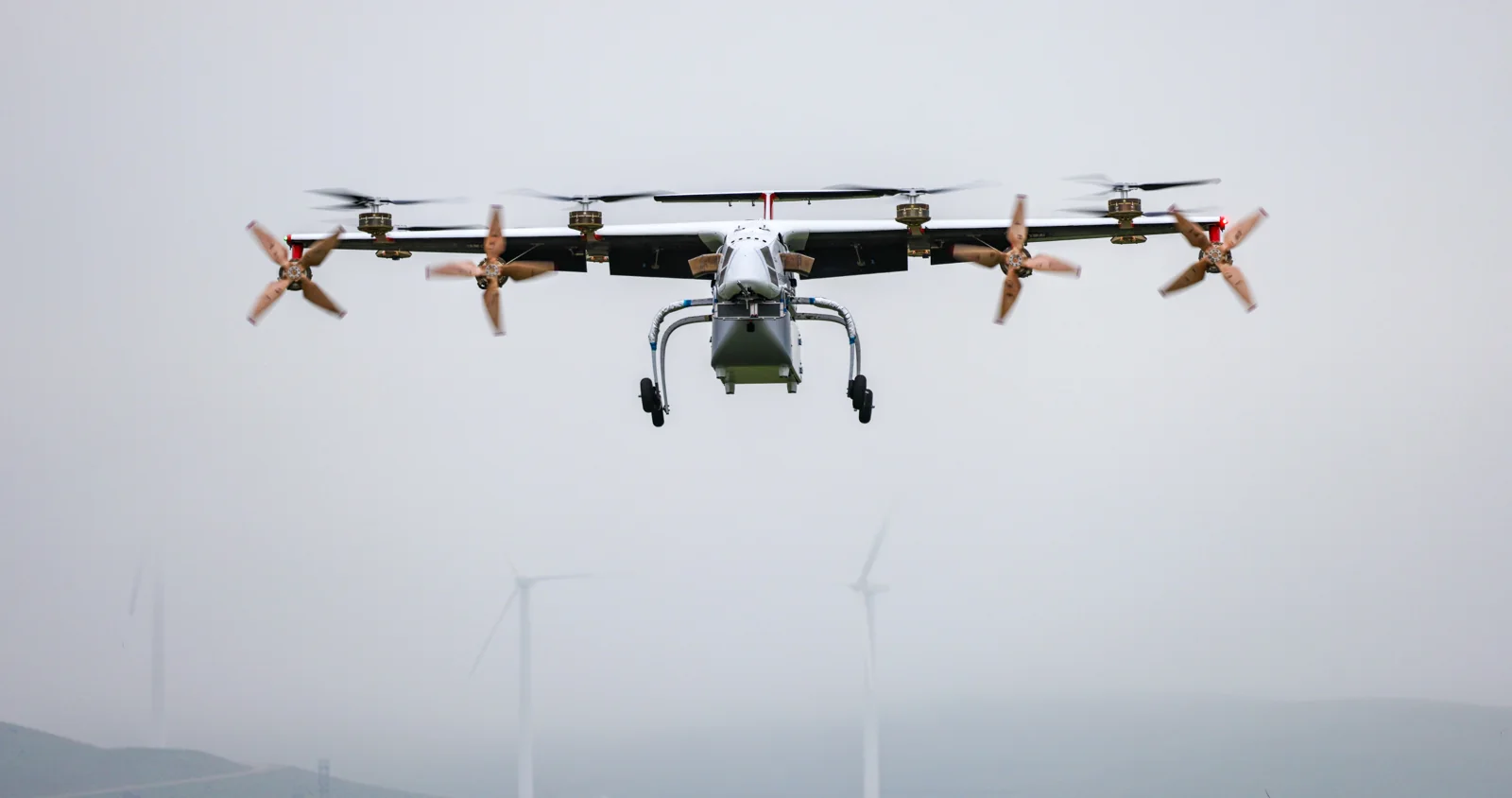 Elroy Air Chaparral autonomous cargo aircraft in flight with cargo suspended beneath its fuselage