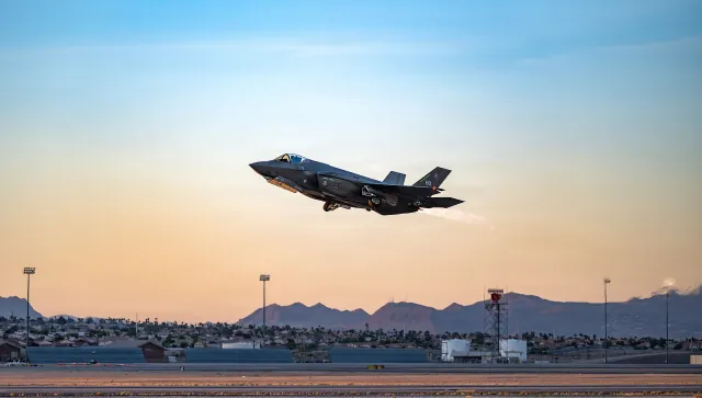 A U.S. Air Force F-35A Lightning II taking off at dusk from Nellis Air Force Base, Nevada