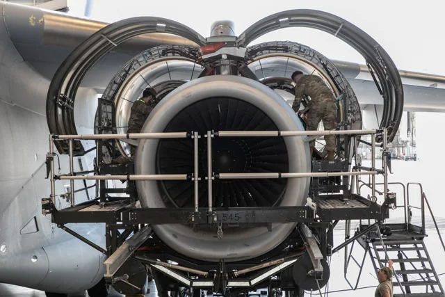 A Pratt & Whitney F117-PW-100 engine with its cowling open during maintenance at Dover Air Force Base
