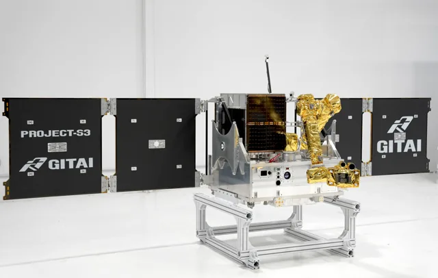 GITAI S3 robotic satellite flight model with deployed panels and robotic arm on a ground fixture