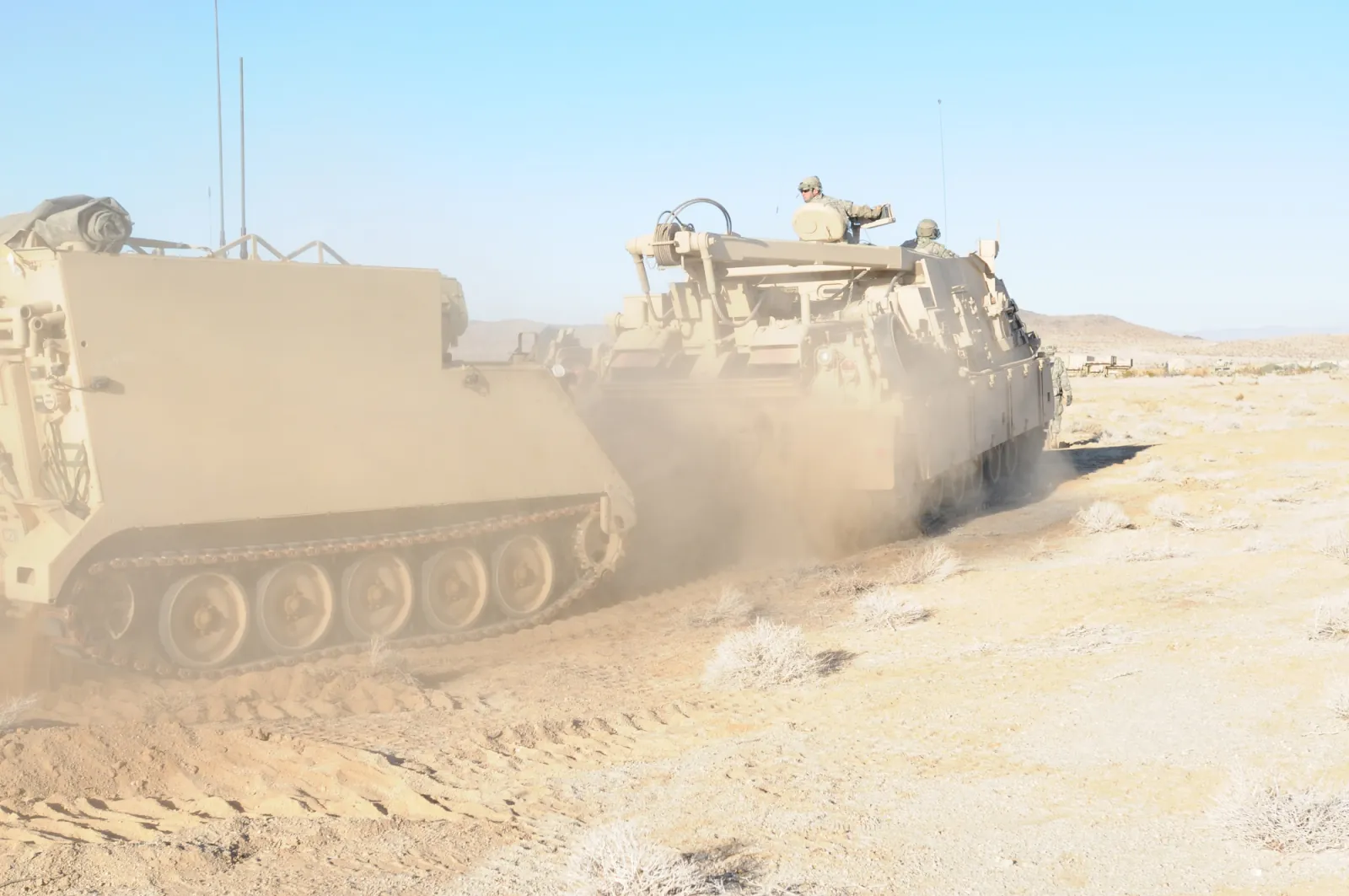 An M88A2 Hercules recovery vehicle towing a disabled M113.