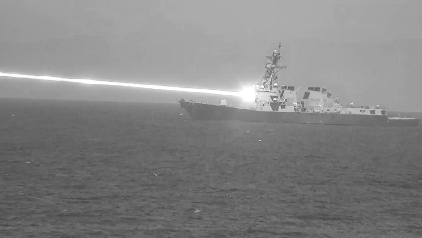 HELIOS laser firing from USS Preble during a U.S. Navy test, shown in a monochrome test image.