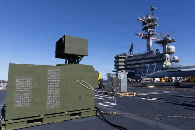 A containerized LOCUST laser weapon system on the flight deck of USS George H.W. Bush