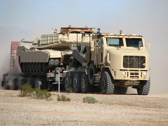 U.S. Army M1070A1 Heavy Equipment Transporter tractor hauling an Abrams tank on a trailer; tractor, trailer and tank have separate cost scopes.