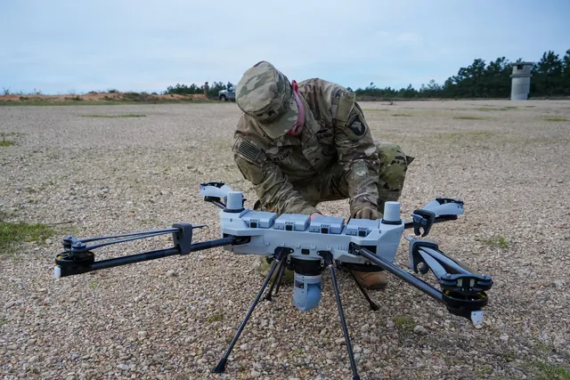 A soldier prepares a PDW C100 quadcopter for flight at the Joint Readiness Training Center.