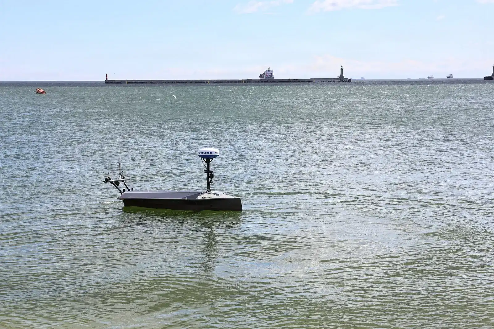 A Seasats Lightfish uncrewed surface vessel underway in the Port of Gdynia during BALTOPS 2026.
