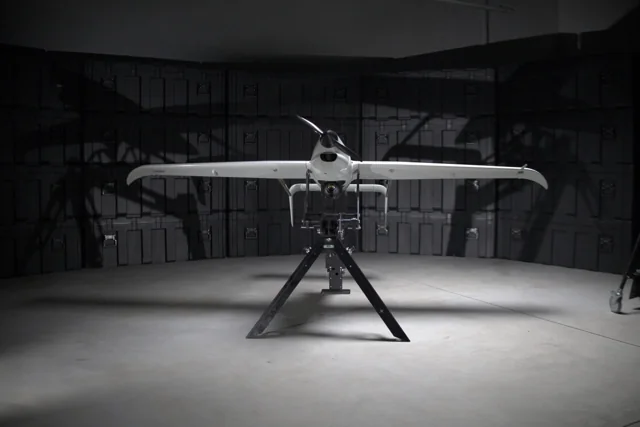 Skyeton Raybird uncrewed aircraft viewed from the front on a stand in a hangar