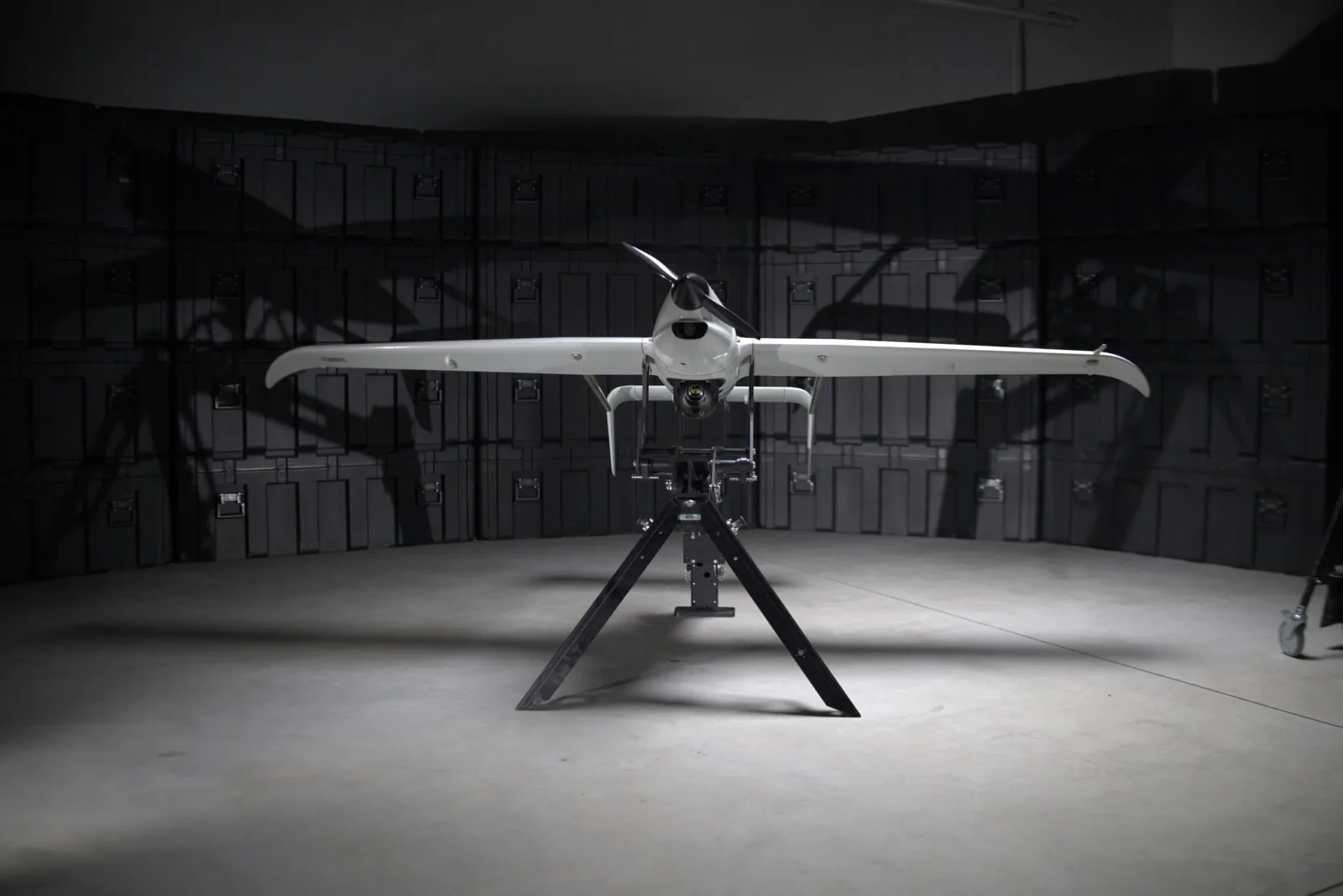 Skyeton Raybird uncrewed aircraft viewed from the front on a stand in a hangar