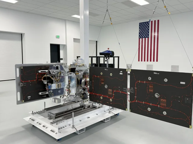 True Anomaly Jackal spacecraft with its solar arrays deployed inside a cleanroom